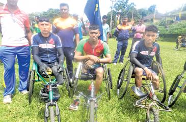 Wheelchair marathon winners after receiving their Awards R.D.A. Somasiri  (center) and runners up, A.H.M. Abeyratne and H.M. Premachandra of Light  Infantry Regiment.  