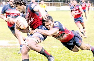 Kandy SC’s  Fazil Marija tackling a CR&FC player during  their  Dialog A division   rugby match at Longden  Place  yesterday.     Pic. Chinthaka Kumarasinghe 