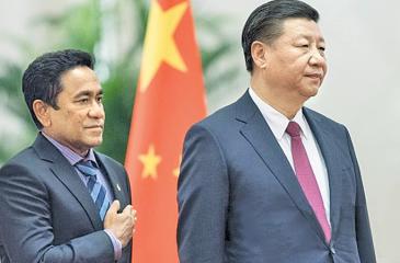 In this file photo taken on December 7, 2017 Maldives’ President Abdulla Yameen (L) and China’s President Xi Jinping listen to their national anthems during a welcome ceremony at the Great Hall of the People in Beijing. Back when he was a mild-mannered civil servant, few in the Maldives predicted Abdulla Yameen would one day run the country, let alone with an iron grip, locking up judges, his rivals and even his 80-year-old half-brother