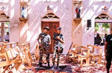 Sri Lankan soldiers look on inside the St Sebastian’s Church at Katuwapitiya in Negombo (AFP)