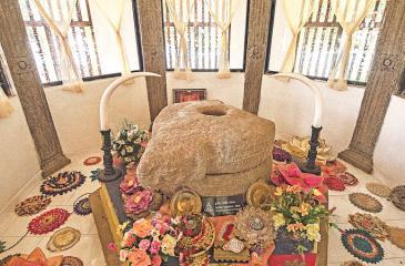 The sacred Grinding Stone displayed in the temple for public veneration