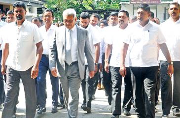 Gotabaya Rajapaksa walks out of the Special High Court in Hulftsdorp surrounded by bodyguards.  Pic courtesy: RepublicNext
