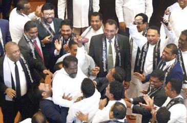 Members of the Sri Lankan parliament shout slogans in support of then ousted prime minister Ranil Wickremesinghe during a parliament session on November 14, 2018. Pic courtesy Lakruwan Wanniarachchi/AFP