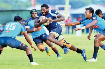 Police Centre Emoci Vunivosa makes a break hotly pursued by two Air Force defenders in their Dialog ‘A’ Division League Rugby match played at Ratmalana yesterday which Police won 36 – 15. Picture by Saman Sri Wedage 