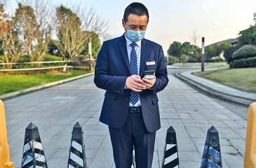 A guard stands at an access area of the Hilton Wuhan Optics Valley Hotel where members of the World Health Organization (WHO) team, investigating the origins of the Covid-19 coronavirus pandemic, are staying after they completed their quarantine in Wuhan, China’s central Hubei province on January 28, 2021.