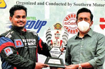 Fastest driver Ushan Perera receiving the coveted Trophy from Chief Marketing Officer SLT-Mobitel Prabath Dahanayake