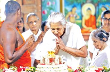 An Upasika (a Buddshist  laywoman) pays homage to  Archaeology Department-protected  Sacred Neelagiri relics at Dharma Rashmi Poson Zone.
