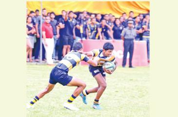 St. Peter’s College player Kushan Tharindu breaks away from a tackle against the Royal College defence (Pic by Sudath Nishantha)