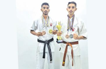 Abdul Kayoom (left) and Raizul Haq pose with their medals