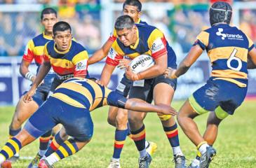 Trinity College’s prop forward Senula Alexander makes a break in their match against Royal College that they won 13-10 at Pallekele yesterday