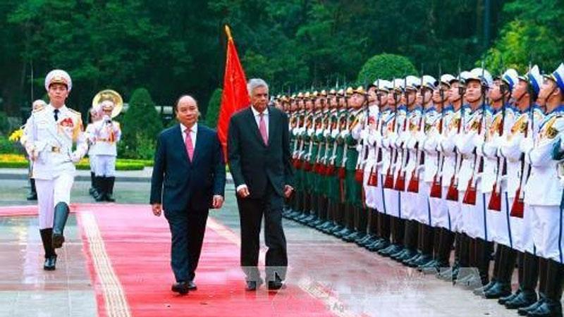 Prime Minister Ranil Wickremesinghe with his Vietnam counterpart Nguyen Xuan Phuc inspect the guard of honour at an official welcoming ceremony for the former in Hanoi on April 17 this year.
