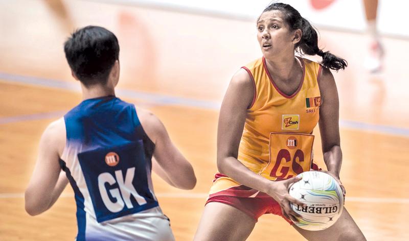 Hasitha Mendis looks up at the net as she targets more points for Sri Lanka