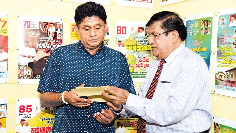 C.A.Wijeyeweere, Chairman, Condominium Management Authority hands over a cheque for Rs. 1m. to the Minister of Housing and Construction, Sajith Premadasa. L.S.Palansooriya, Chairman NDHA and Dhammika Edirisinghe, Accountant, Sevana Fund were present.