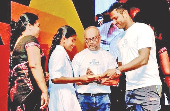 ‘My Friend’ Brand Ambassador Angelo Mathews awarding gifts to children