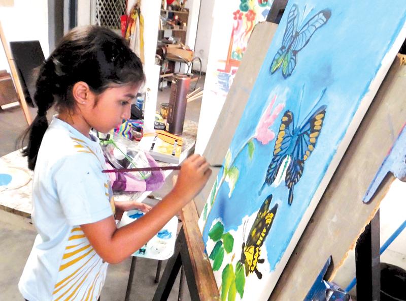 Thihana de Saram adds the final touches to a painting