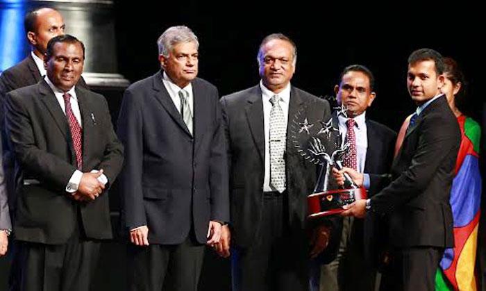 A Fonterra official with the award.