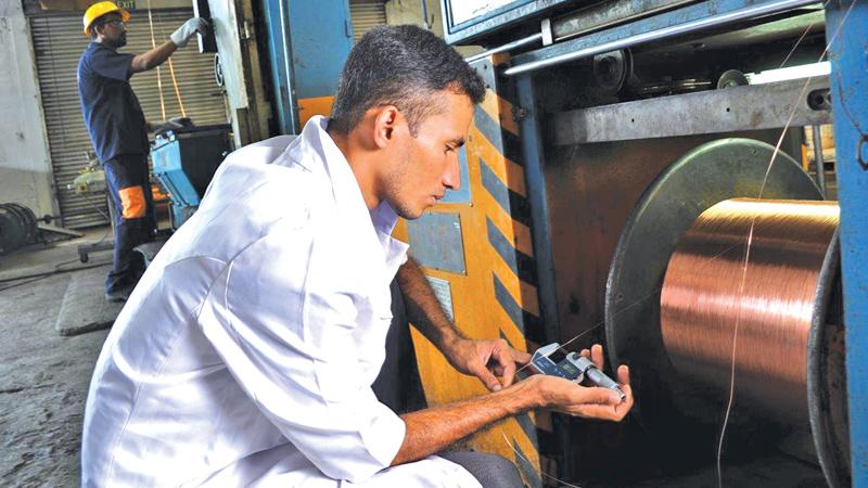 The final check: An employee of Sierra Cables factory at the quality checking point.