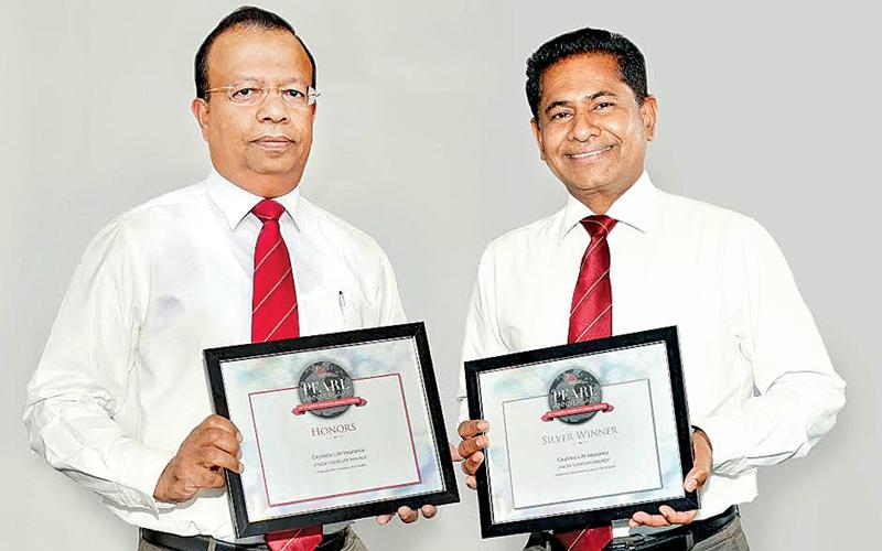 Ceylinco Life Directors Palitha Jayawardena (left) and Ranga Abeynayake with the ARC Awards for the company’s 2015 Annual Report.