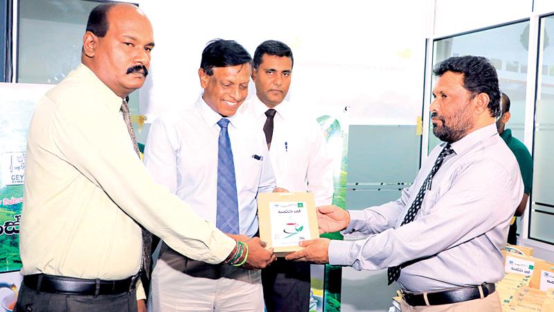 SPC Chairman Thilak Mahanama hands over a Sanstha Tea packet to Addl. Secretary, Ministry of  Public Enterprise Development, M.A. Douglas.Pic: Thilak Perera