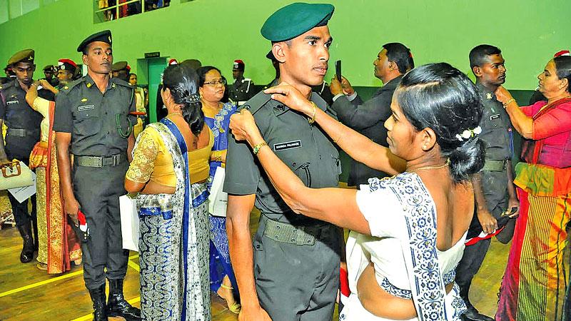 Parents pinning star on sons