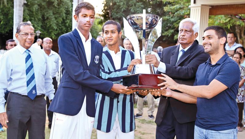 The  two captains  Hiran Cooray (L)(St.Joseph’s) and  Shamod Athulathmudali (Wesley) sharing  the Bryan Classen  trophy  handed  over by old  Wesleyite and  former Sri  Lanka  paceman  L.R.Gunatileka in  the  drawn  centenary  encounter at  Campbell Park  yesterday.      Pic : Thilak Perera