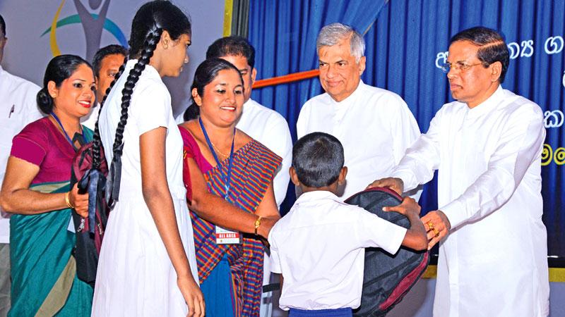  President Maitripala Sirisena and Prime Minister Ranil Wickremesinghe attended the Presidential Mobile Service at the Siri Dhamma Vidyalaya, Labuduwa, Galle yesterday. Here the President Sirisena presents gifts to schoolchildren. Pic: Sudath Malaweera  