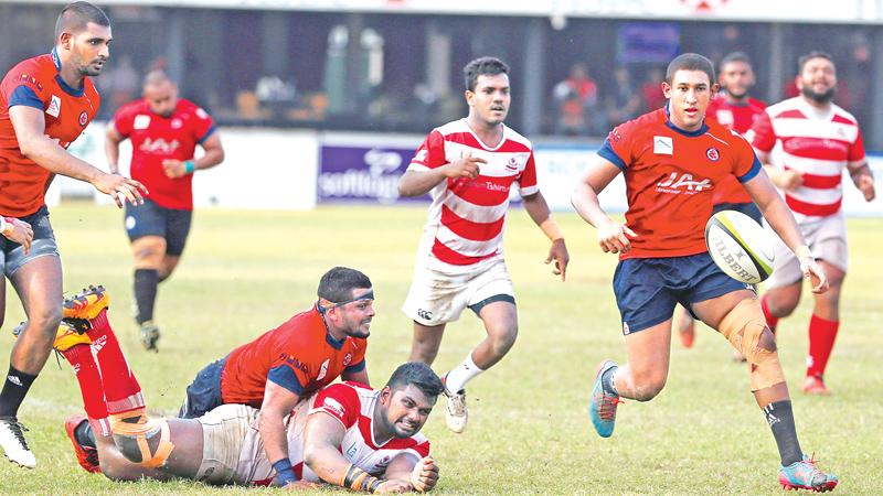 A CH&FC forward is tackled by CR flanker Sasanka Ariyaratne while CR number  8 Tariq Saleih is about to grab the loose ball in the Dialog ‘A’ division  second round rugby match played at Longden Place yesterday. (Pic by Thilak Perera)    