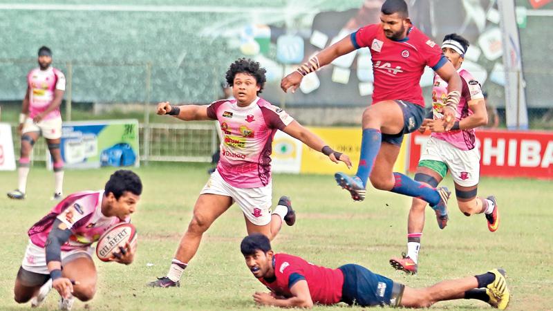 Havies winger Chamara Dabare (with ball in hand) about to sling out a pass to his team mate Sudarshana Muthuthantri in the Dialog ‘A’ division rugby league match against CR&FC at Longden Place yesterday. (Pic Thilak Perera)