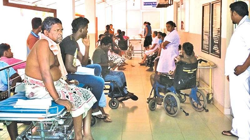 Patients from wards wait at the Dengue Unit for ultrasound scans at night, due to lack of beds inside 