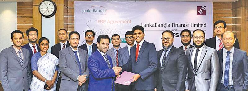 Asanga Marasinghe, Country Director IFS Bangladesh handing over the agreement to Mohammed Nasir Uddin Chowdhury, Managing Director LankaBangla Finance Limited (LBFL) as Shiraz Lye, Director Sales & Marketing, IFS South-Asia, Zahid Khan, Head of Operations, IFS Bangladesh, Sheik Mohammad Fuad, Head of IT/LBFL, Khwaja Shahriar, Deputy Managing Director of LBFL, Shamim Al Mamun, Chief Financial Officer of LBFL, A. K. M. Kamruzzaman, Head of Operations of LBFL and other officials looks on