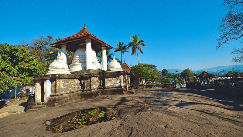 The view of the stupa with a roof and the miniature stupas around it at Gadaladeniya Vihara. 