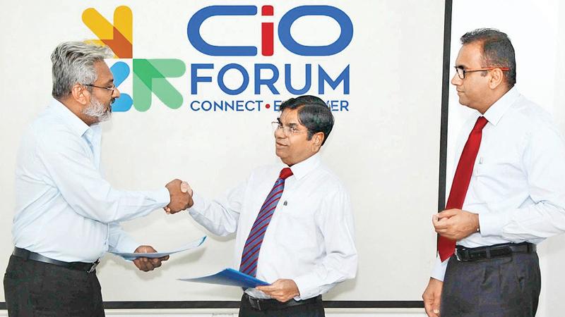 Chairman, Ninehearts Group, Thilak Godamanna (centre) exchanges the MoU with Chairman, FITIS, Wasantha Weerakoon.Vice President of CSSL, Prabath Wickramaratne looks on.