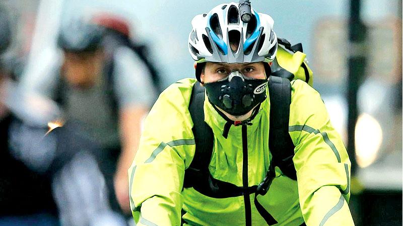 A London cyclist wears a face mask to avoid inhaling pollution  Getty Images    