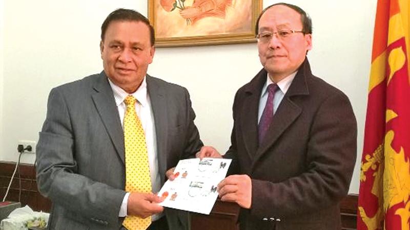 Secretary General of  the China National Philatelic Corporation, Ma Xiaoling presents the Commemorative Cover to Ambassador of Sri Lanka in China, Dr. Karunasena Kodituwakku. 
