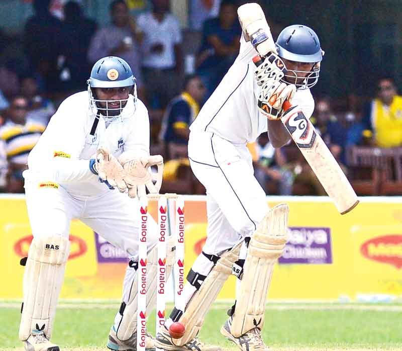 Josephian batsman Nipun Sumasinghe batting in the second innings watched by Peterite skipper and wicket-keeper Lakshina Rodrigo on the second day of the 83rd Battle of the Saints cricket match played at the P Sara Oval yesterday.  (Pic by Saman Mendis)    