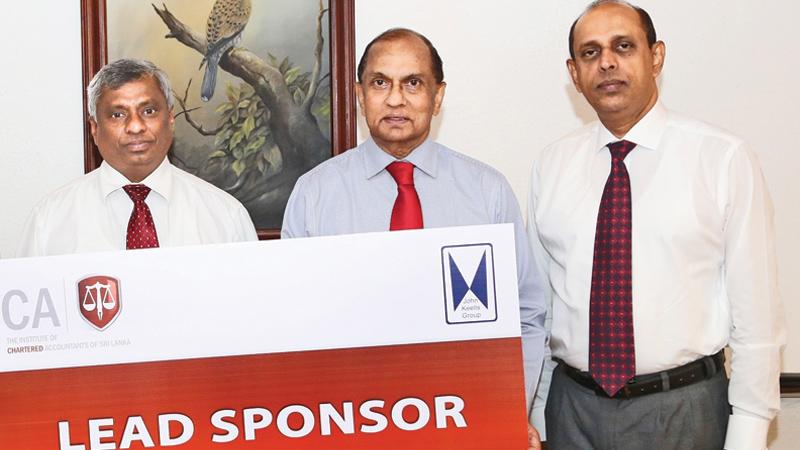 John Keells Holdings Group Finance Director Ronnie Peiris presents the lead sponsorship cheque to CA Sri Lanka President Lasantha Wickremasinghe