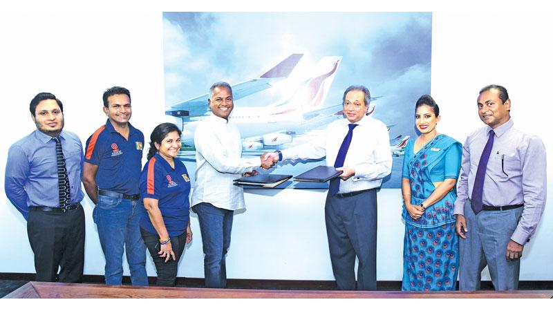 Exchanging the MOU documents:  L-R Niroshan Ranawake - SriLankan Cares Manager, SriLankan Airlines, Suranga Jayasekera - Research and Development Manager, Foundation of Goodness, Fazana Ibrahim - Head of Project Management, Foundation of Goodness, Kushil Gunasekera - Founder/Chief Trustee Foundation of Goodness, Ajith Dias Chairman - SriLankan Airlines, Anushka Ekanayake -  Project Ambassador SriLankan Village Heartbeat Project, PradeepaKekulawala - Head of Human Resources, SriLankan Airlines    