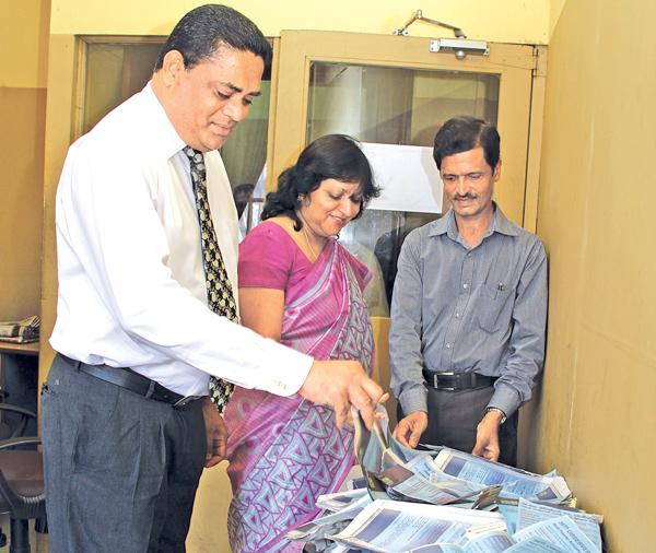 From left. Viraj Boise (DGM Finance), Mrs.Kumudu Gunawardene (Company Secretary ANCL) and Jagath Hewapanna (Editor Mihira) picking the lucky reader's coupon at the 6th week draw