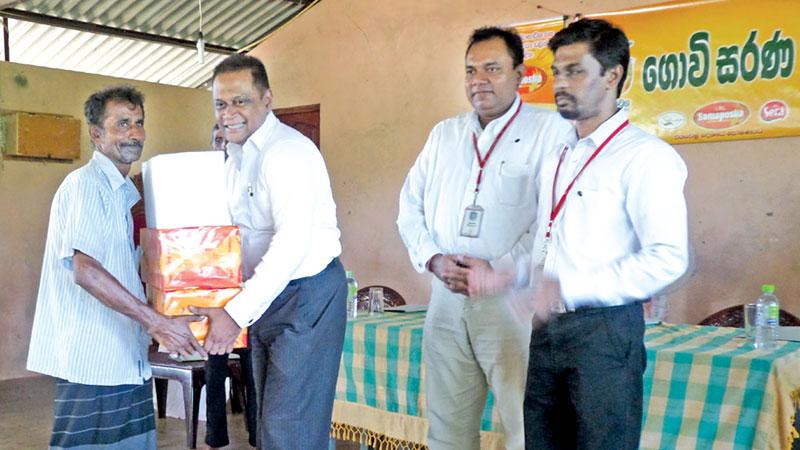 Shammi Karunaratne, Director/Chief Executive Officer – Plenty Foods handing over the provisions to a farmer in the presence of Vasantha Chandrapala, General Manager and Preethiviraj, Agriculture Manager of Plenty Foods.    