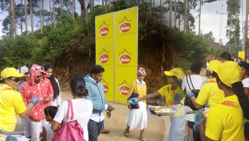 Munchee staff distribute biscuits