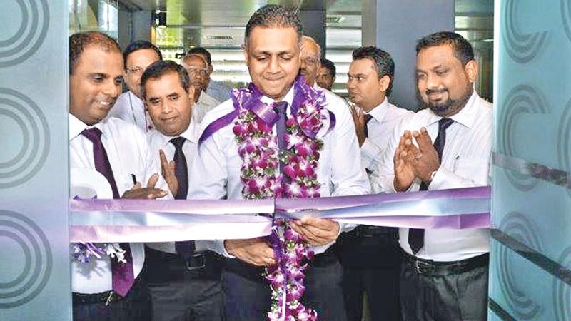 Assistant General Manager, Network Management, HNB, Nirosh Perera, opening the new customer centre. Senior Regional Head,  Eastern Region, Kandiah Jegarajah, Regional Head, Eastern Region, P. Ramanadasa and  Manager, HNB Ampara, Saman  Indika are also in the picture. 