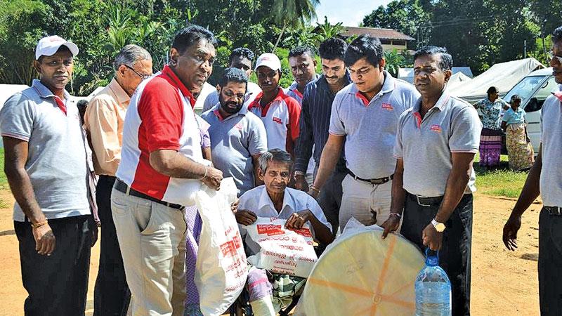 HelpAge officials distributing food items and household goods to victims 