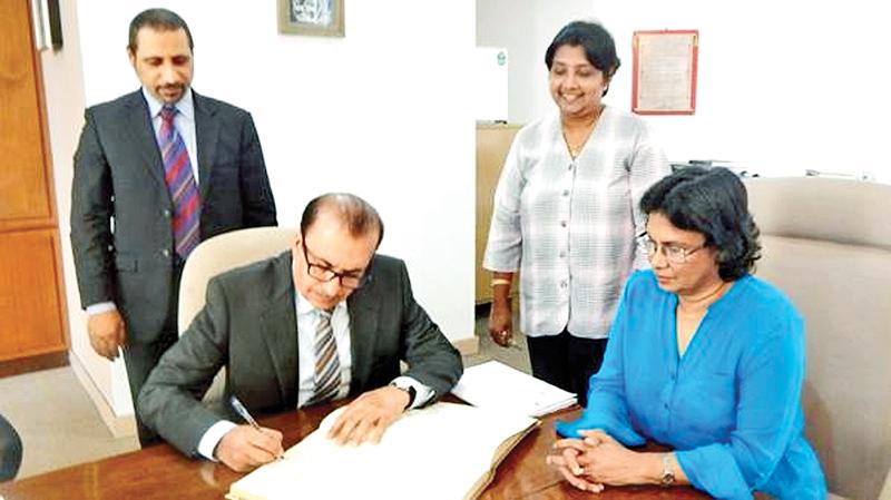 The UAE Ambassador Abdulhamid Abdulfattah K. Al Mulla signs the Visitors’ Book at the Chamber. CEO of the Chamber, Dhara Wijayatilake, Sr. Asst. Secretary General Ms. Lilakshini de Mel and an UAE official look on.   