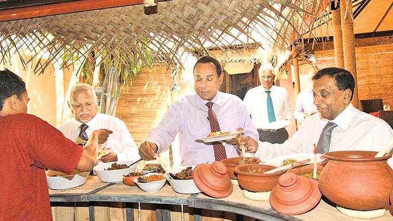 Harry Jayawardena, Niranjan Deva Aditiya, Sanath Ukwatte and Rajan Britto enjoy food at the launch     