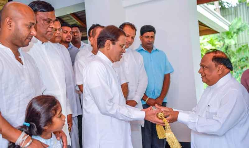 Cultural Affairs Minister S.B. Navinna presents the Avurudu Neketh seettuwa to President Maithripala Sirisena