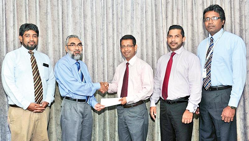 Country Manager of Transnational BPM Lanka (Pvt) Ltd, Dr. Imtiaz Ismail presents the sponsorship cheque to the President of the Clearing Association of Bankers, Upul de Silva. Deputy General Manager of Transnational BPM Lanka (Pvt) Ltd, Thurab Hilmy,  Secretary Razak Deen and Treasurer of the Clearing Association of Bankers, Janak Palugaswewa look on.  