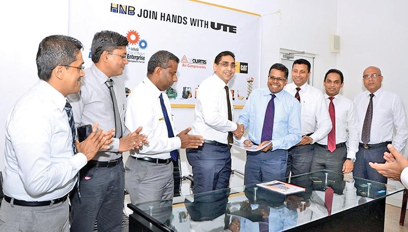 Exchange of the MoU. From left: Marketing Consultant, Michael Ranasinghe, Manager, Industrial Solutions, Sampath Sudarshana, General Manager, Power Systems/Material Handling Solutions /Industrial Solutions and Energy Solutions, ManjulaVithanage, CEO of UTE, Riyad Ismail, COO, HNB, Dilshan Rodrigo, Senior Manager, Personal Financial Services, Kanchana Karunagama, Senior Manager, SME Business Division, Niluka Amarasinghe, and Senior Manager, Leasing, HNB, Jeewantha Perera.     