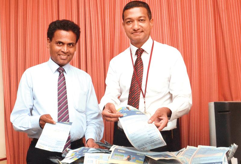 Head of Corporate Planning, Lake House, Sumith Kothalawela (right) and Head of Fund Management, D.M. Danasena picking the lucky coupons among the winners at the end of the 10th week count. Pic. Wimal Karunatileka