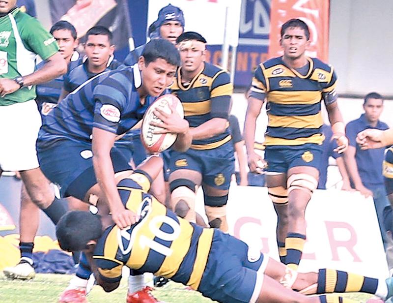 A Thomian player  being tackled by a Royalist  (Pic by Marlon Karunaratne)