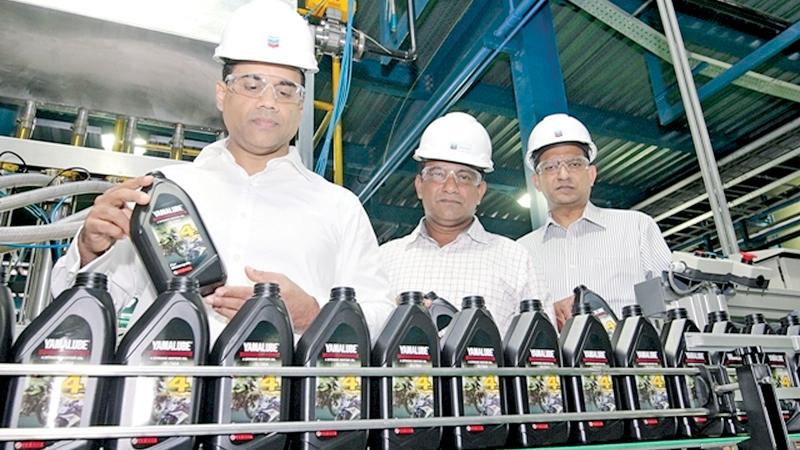 MD/CEO of Chevron Sri Lanka, Kishu Gomes at the first production run of Yamaha Genuine Oil for the Sri Lankan market as it rolls off the production lines of the Chevron Lubricants Lanka PLC manufacturing plant in Sapugaskanda. General Manager, Supply Chain, Wijitha Akmeemana and General Manager, Sales of Chevron Sri Lanka,  Bertram Paul.